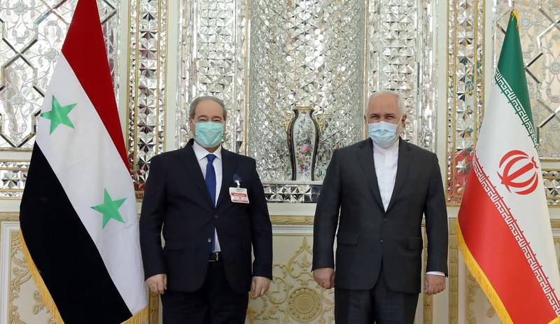 Iran's Foreign Minister Mohammad Javad Zarif (right) welcoming his Syrian counterpart Faisal Mekdad (left) at the Foreign Ministry office in Tehran, Iran.  EPA