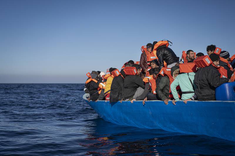 Migrants and refugees, sailing adrift on an overcrowded wooden boat in the Mediterranean Sea, wait to be helped by Spanish NGO Aita Mary. AP Photo