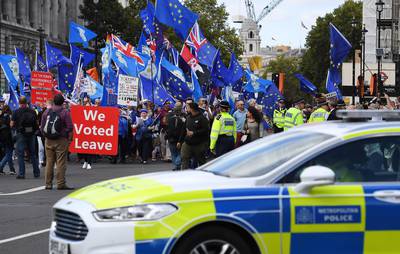 Pro Remain and pro Leave campaigners face off outside the British Houses of Parliament. EPA