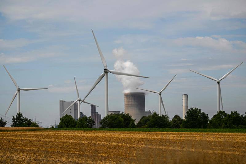Wind turbines in front of a coal-fired power plant operated by German energy supplier RWE in Niederaussem. AFP