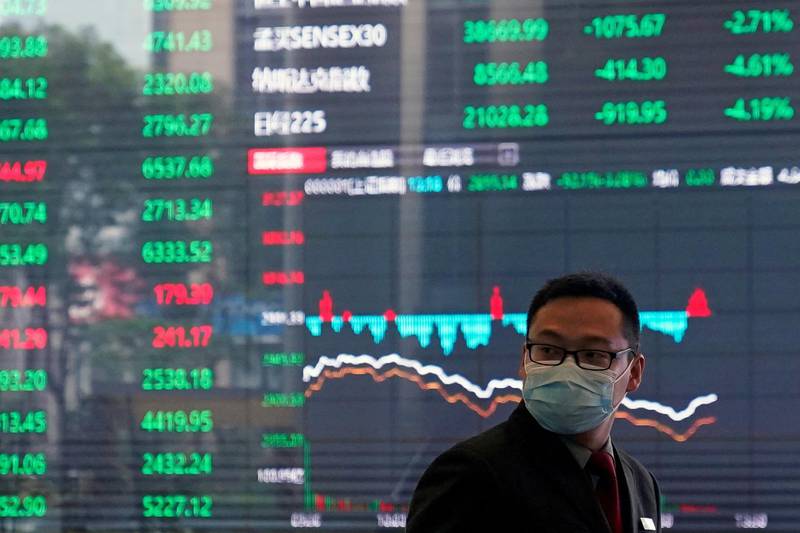 A man wearing a protective mask is seen inside the Shanghai Stock Exchange building, as the country is hit by a new coronavirus outbreak, at the Pudong financial district in Shanghai, China. Reuters
