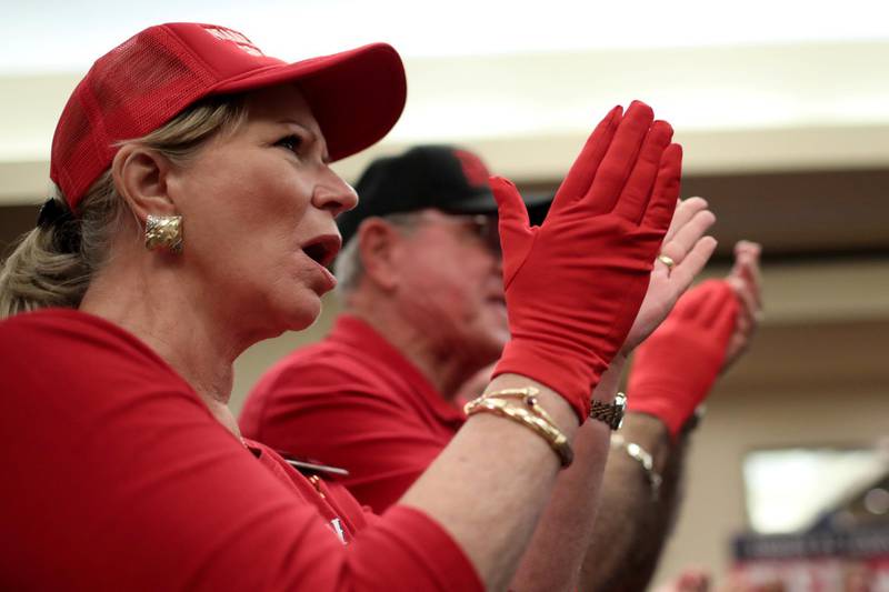 Supporters of Ted Cruz applaud wearing 'Red Wave' gloves at a campaign rally in Victoria, Texas. Reuters