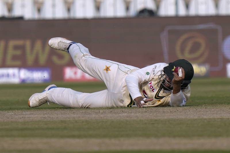 Pakistan fielder Abdullah Shafique takes a catch to dismiss England's Joe Root for 21. AP