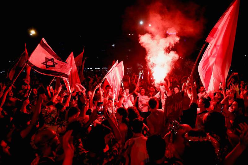 People celebrate after Israel's parliament voted in a new coalition government, ending Benjamin Netanyahu's 12-year hold on power, at Rabin Square in Tel Aviv, Israel. Reuters