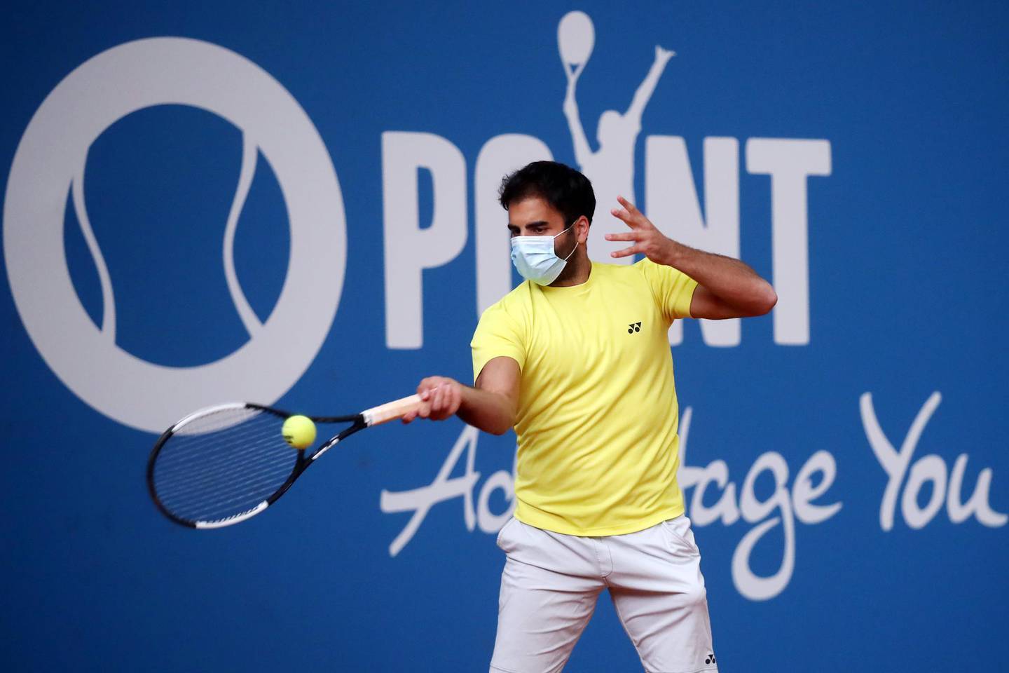 HOHR-GRENZHAUSEN, GERMANY - MAY 02: Benjamin Hassan of Germany wears a face mask as he warms up during day 2 of the Tennis Point Exhibition Series on May 02, 2020 in Hohr-Grenzhausen, Germany. The tournament is the first since the suspension of all matches at the beginning of March and one of the first non-virtual sporting events held during the Coronavirus crisis. (Photo by Alex Grimm/Getty Images)