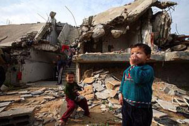 Palestinian children play amid the rubble of their house,  
which was destroyed during the three-week Israeli offensive that started on December 28 last year.