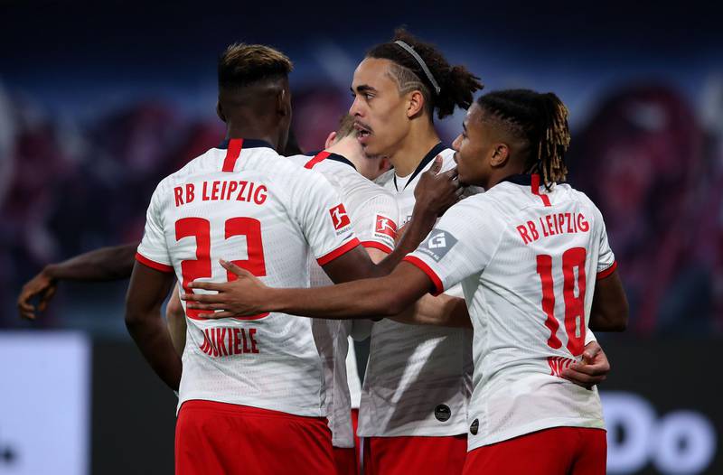 Leipzig's Danish forward Yussuf Poulsen (2nd R) celebrates scoring the 3-1 with his team-mates Leipzig's French midfielder Christopher Nkunku (R) and Leipzig's French defender Nordi Mukiele (L) during the German first division Bundesliga football match RB Leipzig v FC Augsburg in Leipzig, eastern Germany, on December 21, 2019. DFL REGULATIONS PROHIBIT ANY USE OF PHOTOGRAPHS AS IMAGE SEQUENCES AND/OR QUASI-VIDEO 
 / AFP / Ronny Hartmann / DFL REGULATIONS PROHIBIT ANY USE OF PHOTOGRAPHS AS IMAGE SEQUENCES AND/OR QUASI-VIDEO 
