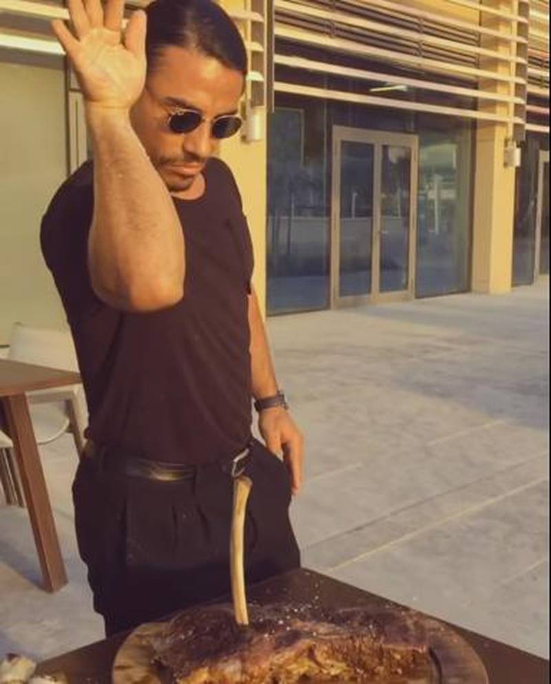 Nusret Gokce (also known as ‘Salt Bae’) throws salt on to a piece of meat. YouTube