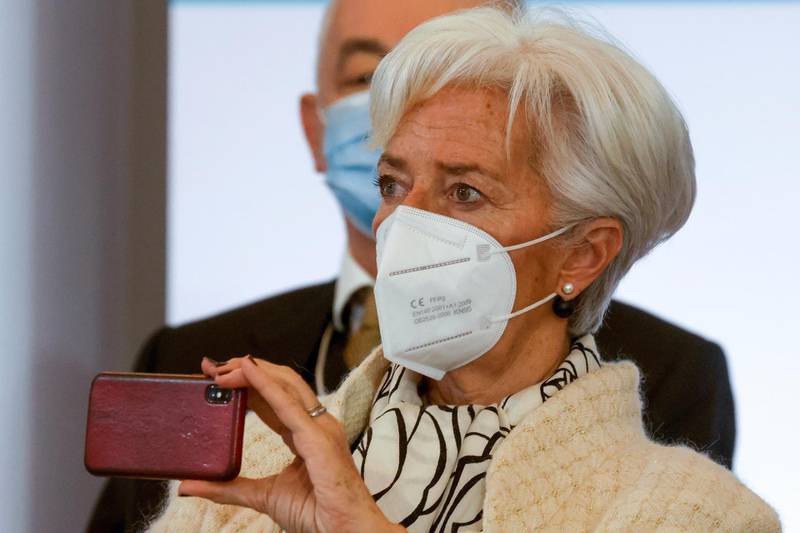 President of the European Central Bank (ECB) Christine Lagarde holds her smartphone as she attends the One Planet Summit, at The Elysee Palace, in Paris, Monday Jan. 11, 2021. Protecting the world's biodiversity is on the agenda for world leaders at the One Planet Summit, which was being held by videoconference due to the coronavirus pandemic. (Ludovic Marin, Pool Photo via AP)