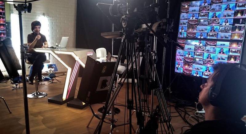 A news presenter and a cameraman work at the studio of Russia's only independent TV channel Dozhd in a living room in Moscow. Naira Davlashyan / AFP