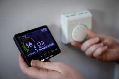 A smart energy meter, used to monitor gas and electricity use, and a central heating thermostat dial at a home in London. The UK energy bill could force householders to adopt smart appliances. EPA