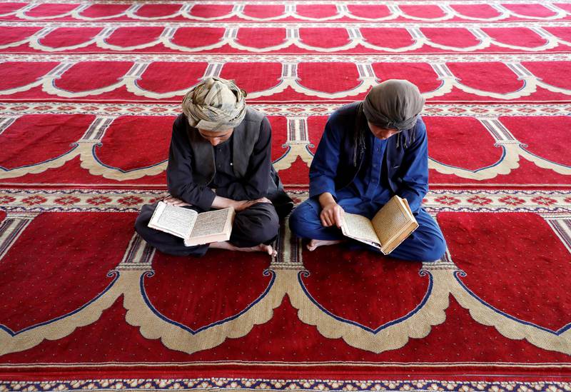 Afghan men read the Quran at a mosque during the holy month of Ramadan in Kabul, Afghanistan. Reuters