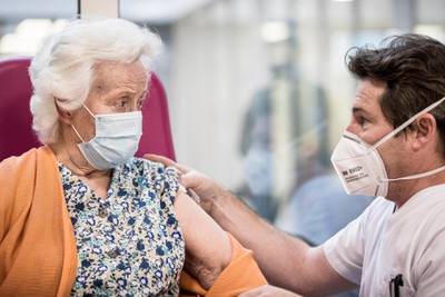 A nurse talks to a resident after administering a Pfizer-BioNTech vaccine at the Ange-Raymond Gilles care home in Jemeppe-sur-Meuse, near Liege, Belgium. AP Photo