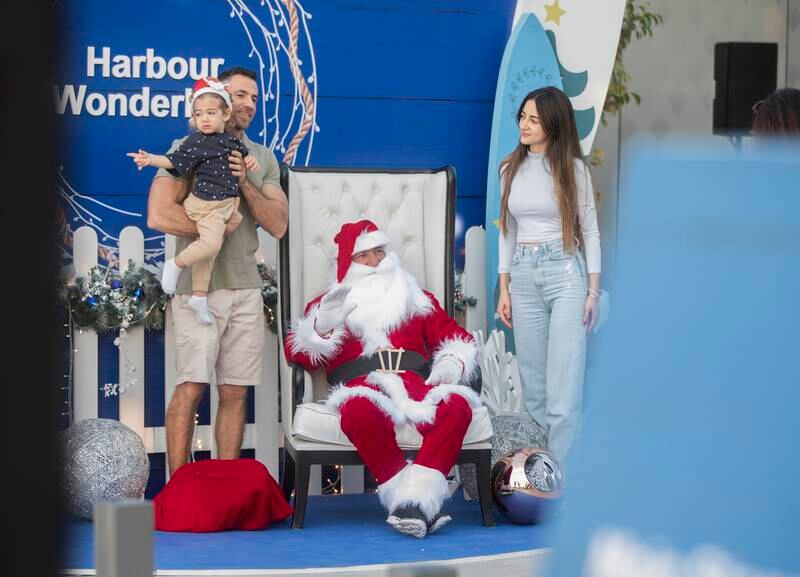 Visitors take photographs with Santa Claus.