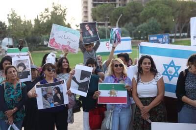 Israelis show their support for women in Iran as they hold up placards of Amini during a protest in Jerusalem. EPA