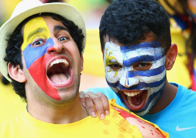 A Uruguay fan pretends to bite the shoulder of a Colombian fan ahead of the two teams' match on Saturday at the 2014 World Cup in Rio de Janeiro, Brazil. Julian Finney / Getty Images