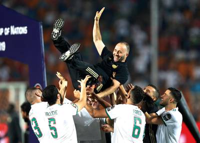 Algeria's players throw their manager Djamel Belmadi in celebration. AP