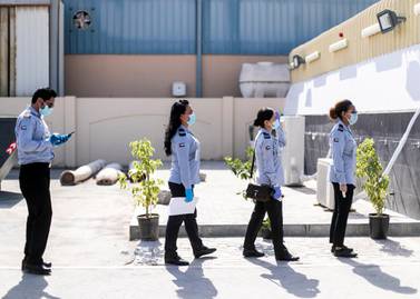 Security guards line up to be tested at a clinic in Mussaffah. Any commercial or industrial company regulated by Abu Dhabi's Department of Economic Development must ensure their staff are tested. Reem Mohammed / The National