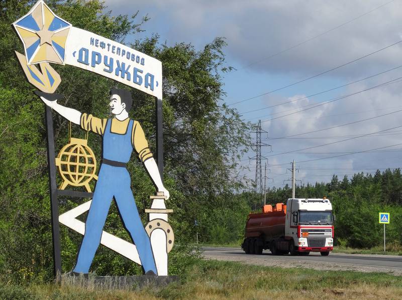 A fuel tanker passes a sign for the Druzhba oil pipeline near Samara, Russia. Reuters