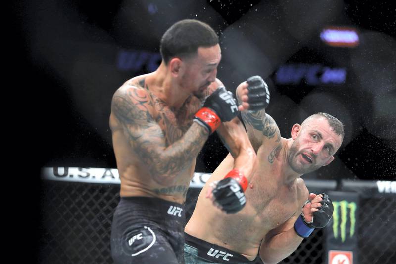 LAS VEGAS, NEVADA - DECEMBER 14: Alexander Volkanovski (R) punches UFC featherweight champion Max Holloway in their title fight during UFC 245 at T-Mobile Arena on December 14, 2019 in Las Vegas, Nevada. Volkanovski took the title by unanimous decision.   Steve Marcus/Getty Images/AFP