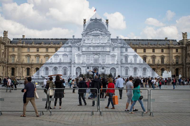 epa07434428 (FILE) A view of the Pyramid of the Louvre museum covered with a gigantic black and white trompe l'oeil photo of the Louvre building by French artist JR in Paris, France, 25 May 2016 (reissued 13 March 2019). Built by US-Chinese architect Ieoh Ming Pei, the Louvre Pyramid celebrates the 30th anniversary of its inauguration, dated 30 March 1989.  EPA-EFE/JEREMY LEMPIN