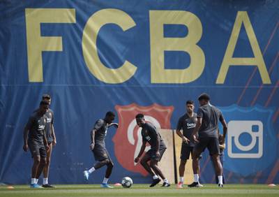 Barcelona's players Ansu Fati , Nelson Semedo and Luis Suareztake part in a training sessio. EPA
