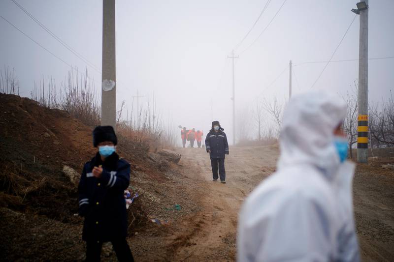 Security members keep watch at an entrance to the Hushan gold mine where workers are trapped underground after the January 10 explosion, in Qixia, Shandong province, China. Reuters