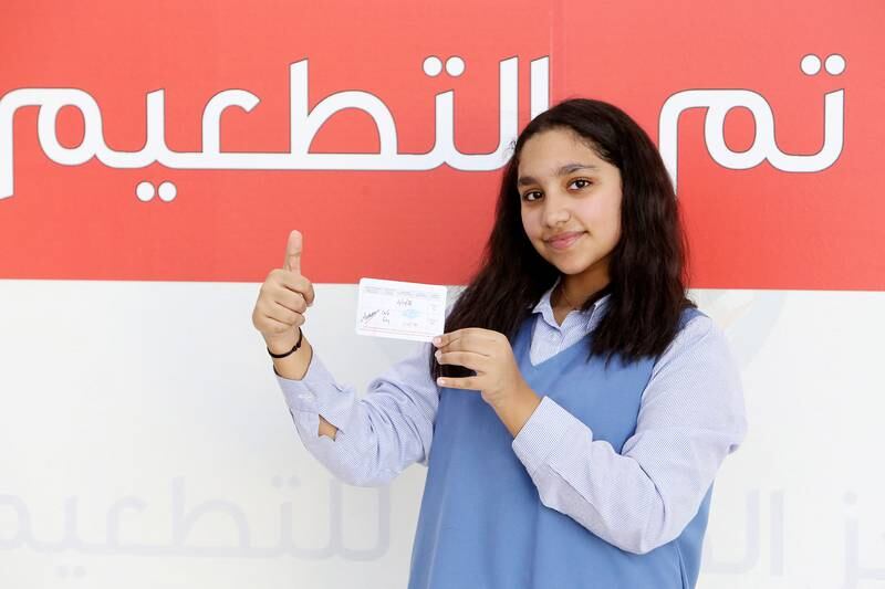 Kuwaiti pupil Awrad, 12, shows her vaccination card after receiving her second dose of a Covid-19 vaccination in Kuwait City. People wishing to apply for visas must be fully vaccinated. AFP