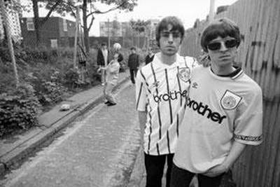Singer Liam Gallagher, left, and his brother Noel, of rock band Oasis, sport their Manchester City football shirts in 1994.