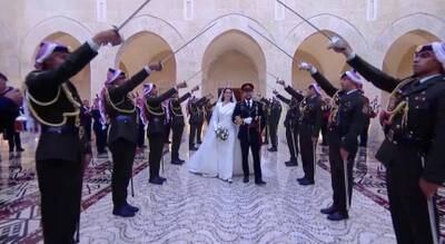 An honour guard surrounds the royal couple as they arrive at Al Husseiniya Palace. Reuters