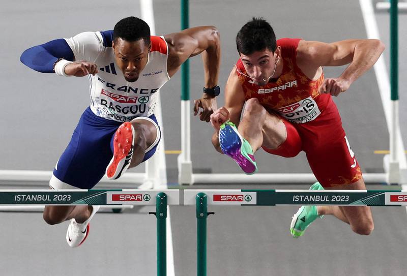 French athlete Dimitri Bascou and Spain's Enrique Llopis compete in the men's 60-metre hurdles at the European Athletics Indoor Championships in Istanbul. Reuters