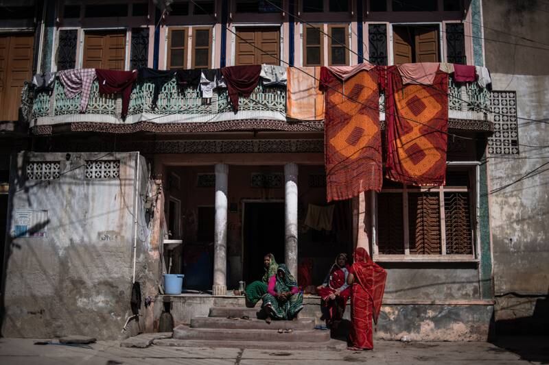 Block print workers gather outside a house in the village.