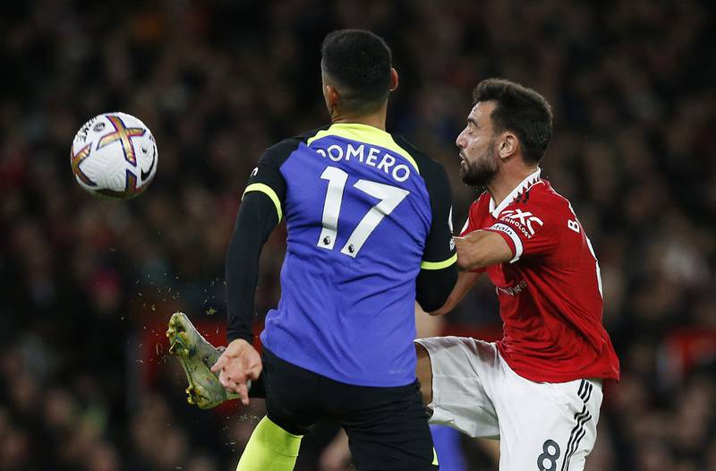 Manchester United's Bruno Fernandes in action with Tottenham's Cristian Romero. Reuters