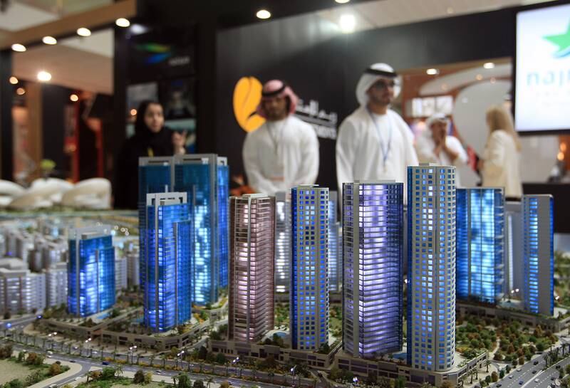 ABU DHABI - UNITED ARAB EMIRATES - 17APRIL2013 - Visitors look at a model of Najmat project by Reem Investments on the second day at Cityscape Abu Dhabi 2013 at Abu Dhabi National Exhibition Centre. Ravindranath K / The National