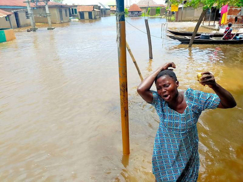 A woman grieves following a boat accident in Anambra, Nigeria, on October 7, 2022. Seventy-six people are missing after the boat capsized in a flooded community in Nigeria's south-east Anambra state, emergency officials said. AP