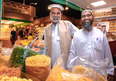 Abu Dhabi, United Arab Emirates, January 5, 2020. Photo essay of Global Village. -- Cousins and partners of Karachi Nimko, a snack stall which sells peanuts, peas and other finger snacks. Both from Islamabad, Pakistan.Malik Abdul Rehman, 49, right,  and Mohammad Bashir, 50.  They have been operating the shop for eight years now.Victor Besa / The NationalSection:  WKReporter:  Katy Gillett