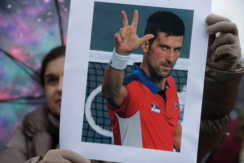 A supporter of Serbian tennis player Novak Djokovic holds a photo during a protest of support in Belgrade, Serbia, 08 January 2022. EPA