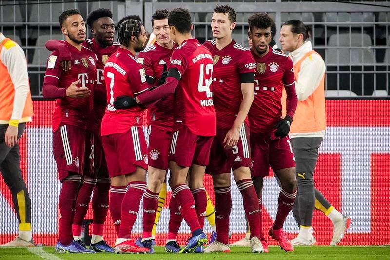 Bayern's Robert Lewandowski celebrates with teammates after scoring the penalty to make it 3-2. EPA