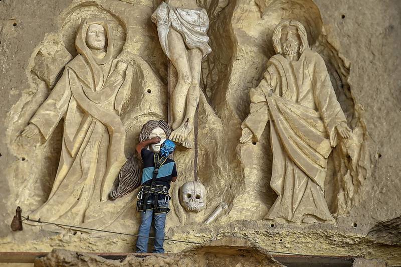 Polish artist Mario, sculptor of St. Simon the Tanner Monastery complex, works on a scene relief depicting the Crucifixion of Jesus Christ, at the church in the Egyptian capital Cairo's eastern hillside Mokattam district. Mario spent more than two decades carving the rugged insides of the seven cave churches and chapels of the rock-hewn St. Simon Monastery and church complex atop Cairo's Mokattam hills, with designs inspired by biblical stories. It was all done to fulfil the wishes of the church's parish priest who met Mario in the early 1990s in Cairo. The Polish artist, who had arrived in Egypt earlier on an educational mission, was then looking for an opportunity to serve God at the monastery. AFP