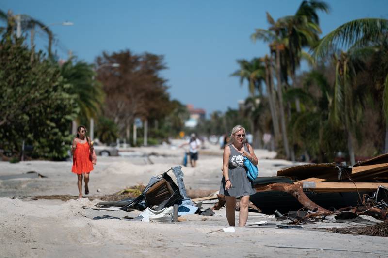 People wander the wreckage at a beach community in Bonita Springs, Florida, in the aftermath of Hurricane Ian. AFP