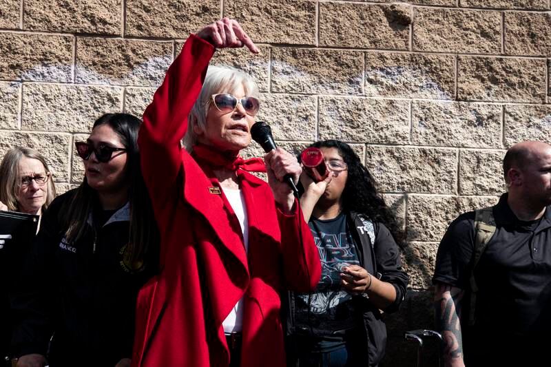Jane Fonda, in a red coat, speaks during a climate change rally in Wilmington, California, on March 6, 2020