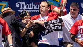 Joey Chestnut puts animal rights protester in chokehold during hot dog eating contest