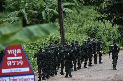 Thai soldiers walk into to the Tham Luang cave area as the operations continue. AFP