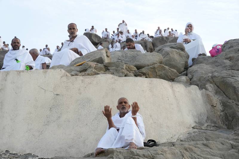 Pilgrims pray on top of Mount Arafat. AP