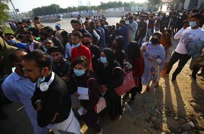 Spectators line up to enter the National Stadium in Karachi. EPA