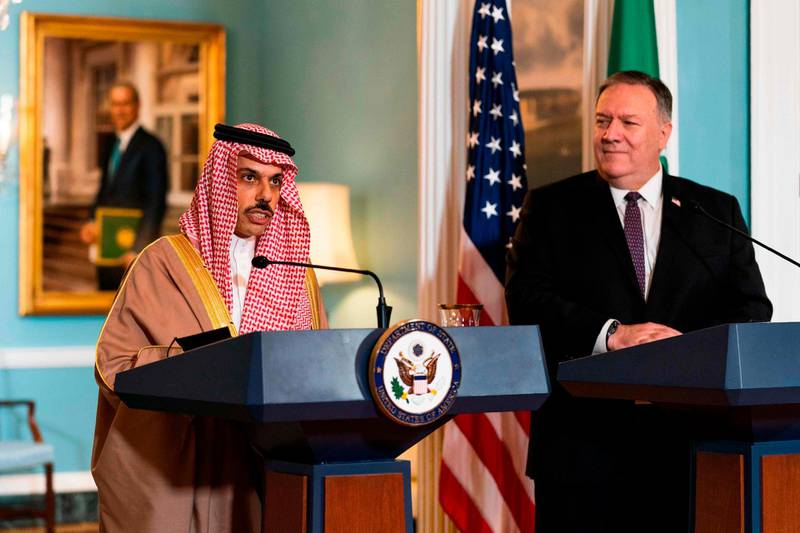 Secretary of State Mike Pompeo, right, listens to Saudi Minister of Foreign Affairs Prince Faisal bin Farhan Al Saud speaks during their meeting at the State Department, October 14, 2020, in Washington, DC.   / AFP / POOL / Manuel Balce CENATA
