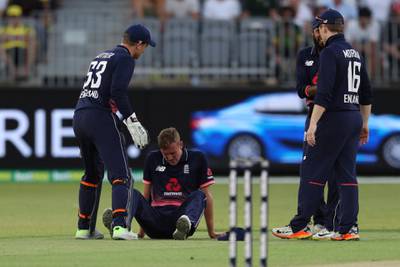 England's Jake Ball sits on the ground after he became unwell during their one day international cricket match against Australia in Perth, Australia, Sunday, Jan. 28, 2018. Ball had to leave the ground. (AP Photo/Trevor Collens)