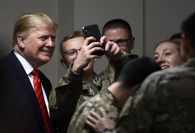 US President Donald Trump poses for selfies. AFP