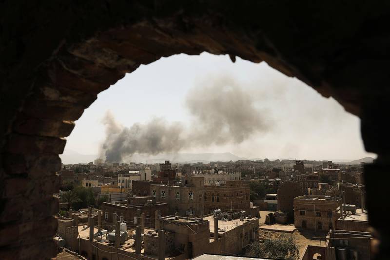 Smoke and dust rise near buildings from air strikes launched by Saudi-led coalition on Sanaa, Yemen March 7, 2021. REUTERS/Khaled Abdullah