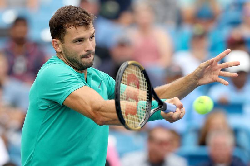 MASON, OH - AUGUST 17: Grigor Dimitrov of Bulgaria returns a shot to Novak Djokovic of Serbia during the Western & Southern Open at Lindner Family Tennis Center on August 17, 2018 in Mason, Ohio.   Matthew Stockman/Getty Images/AFP
== FOR NEWSPAPERS, INTERNET, TELCOS & TELEVISION USE ONLY ==

